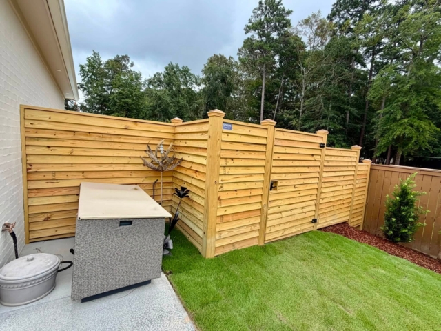 Custom wooden fence with copper caps Custom wooden fence with copper caps
