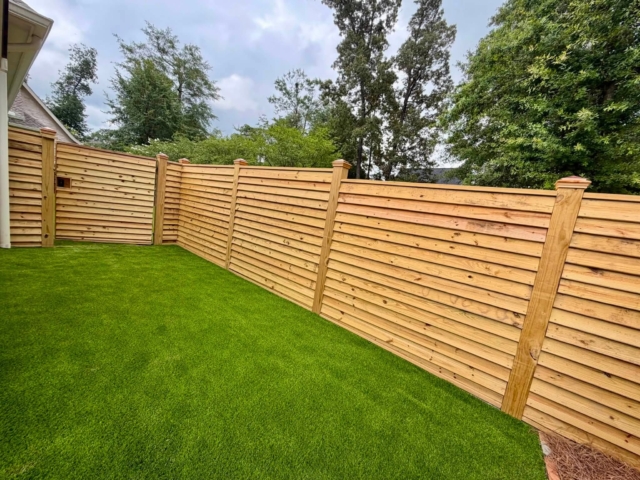 Custom wooden fence with copper caps Custom wooden fence with copper caps